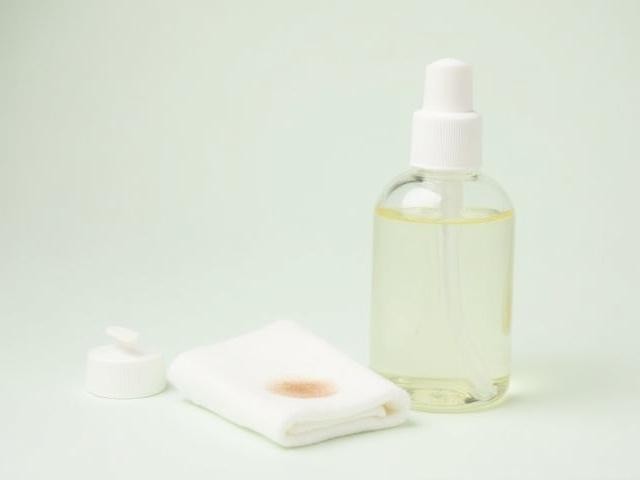Herbal Gleam Herbal Stain Remover, small bottle with concentrated liquid next to fabric swatch